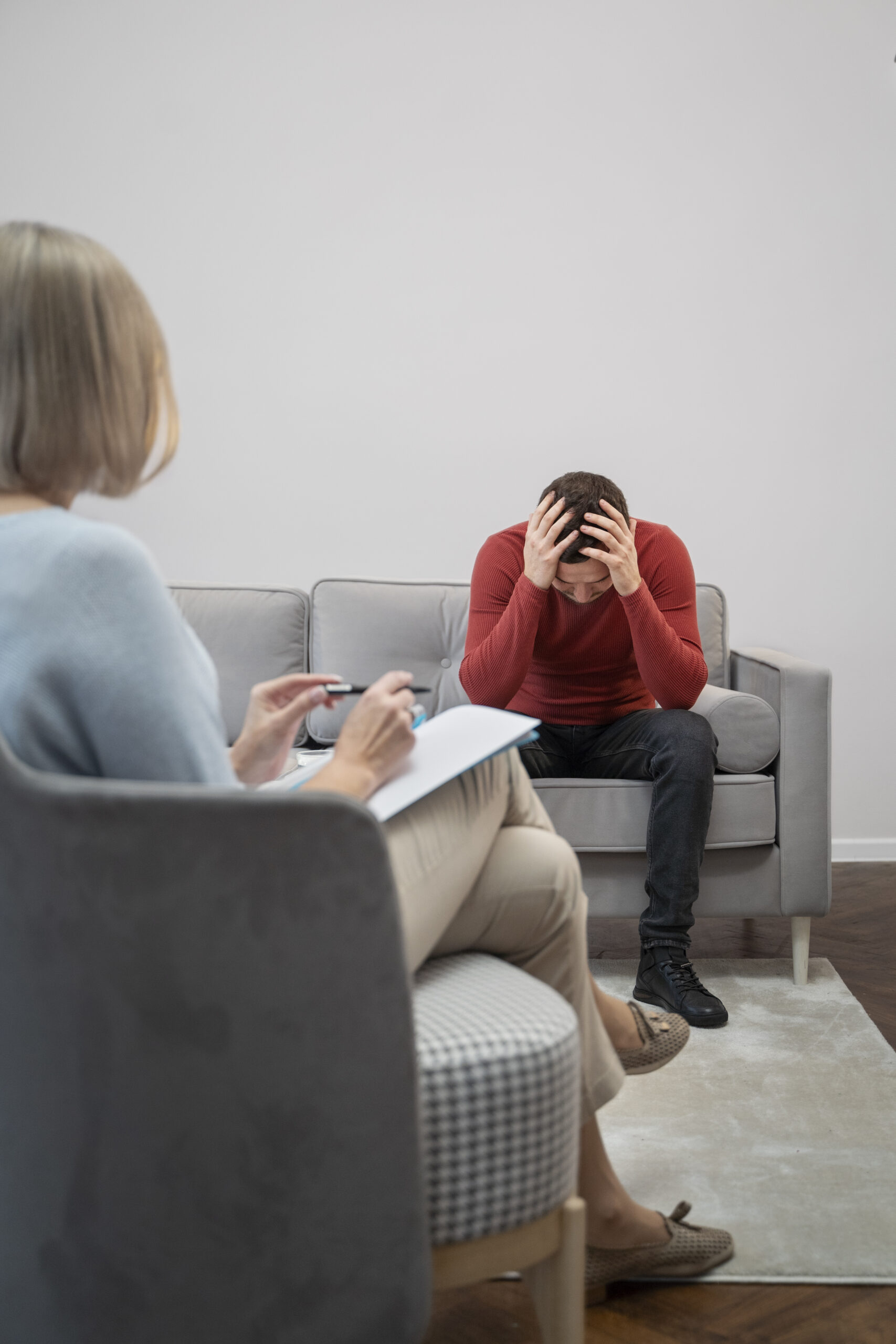 Man in therapy session distressed