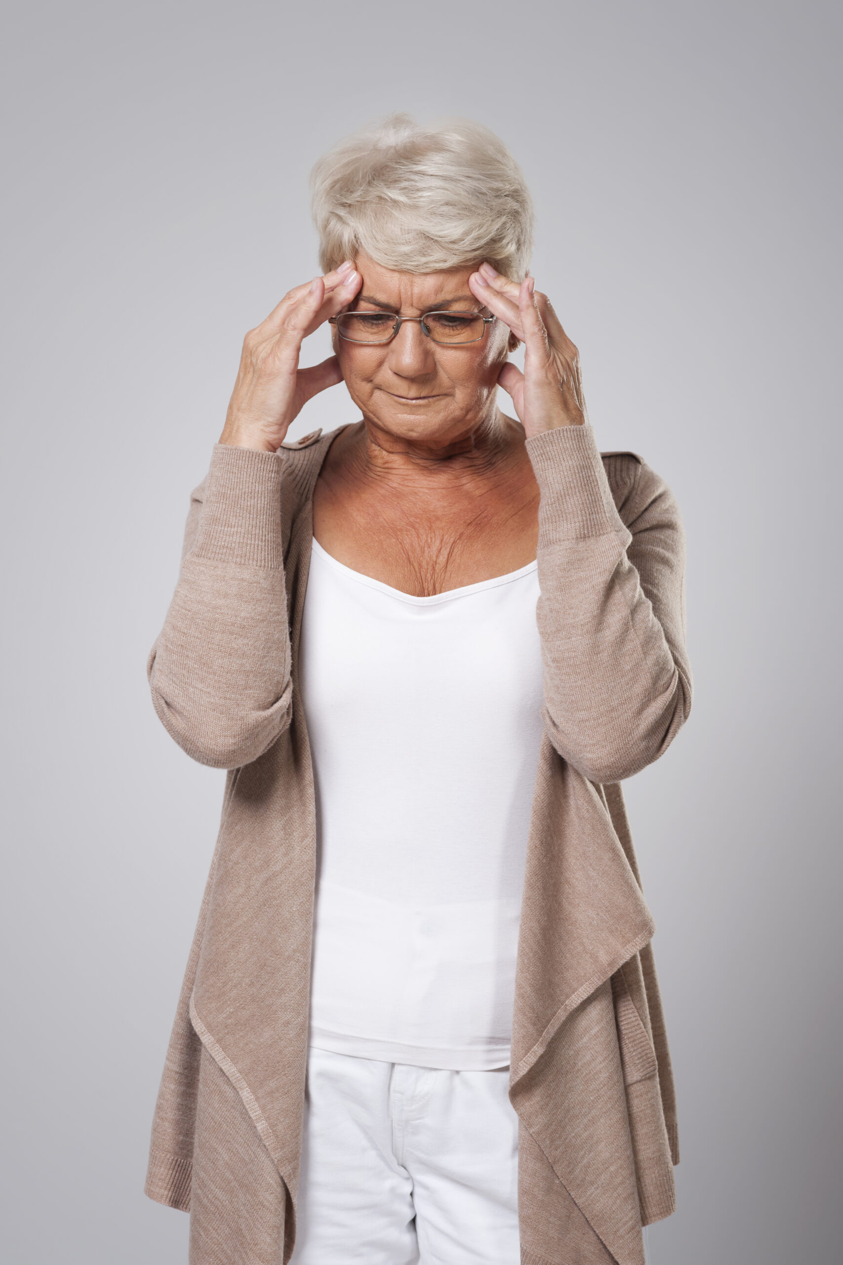Senior woman holding her head in pain